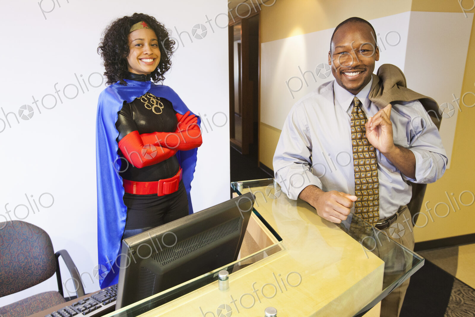 A black businesswoman office super hero and her black businessman partner in their…