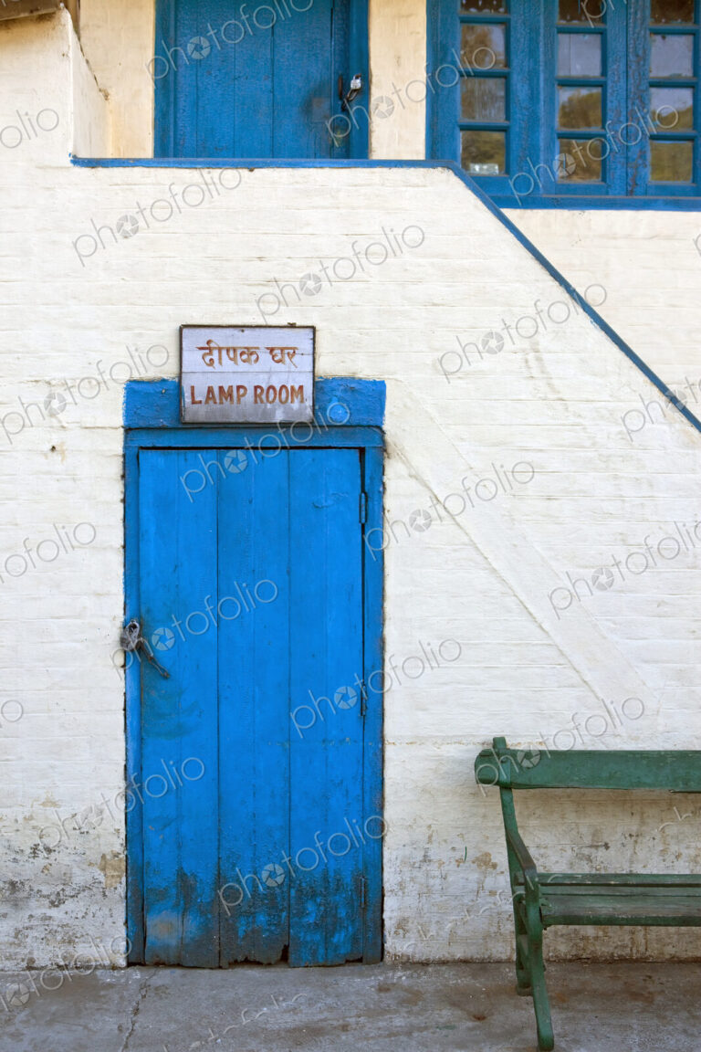 A blue door in a white wall with a sign, Lamp Room, the station of the Kalka-Shimla…