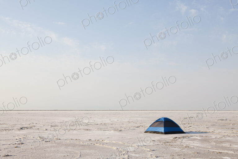 A blue tent on Bonneville Salt Flats at dusk.