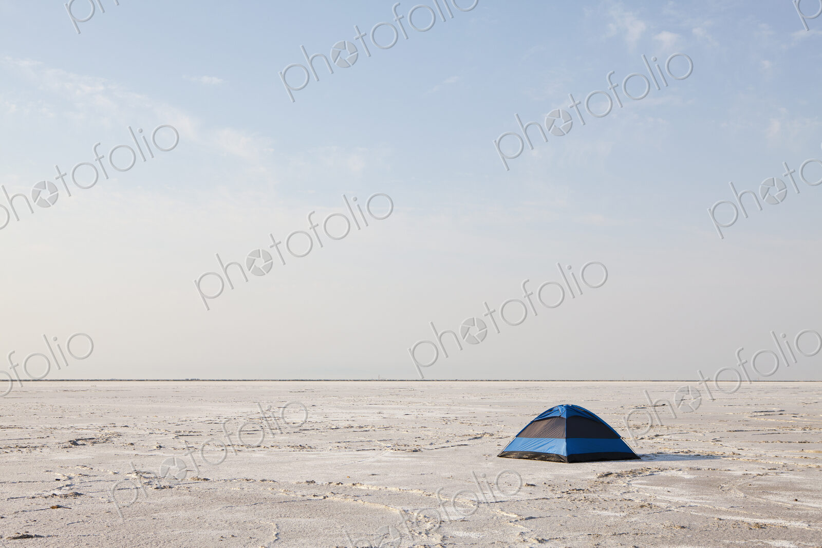 A blue tent on Bonneville Salt Flats at dusk.