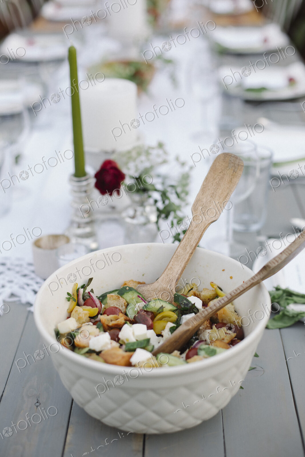 A bowl of salad on a table in a garden.