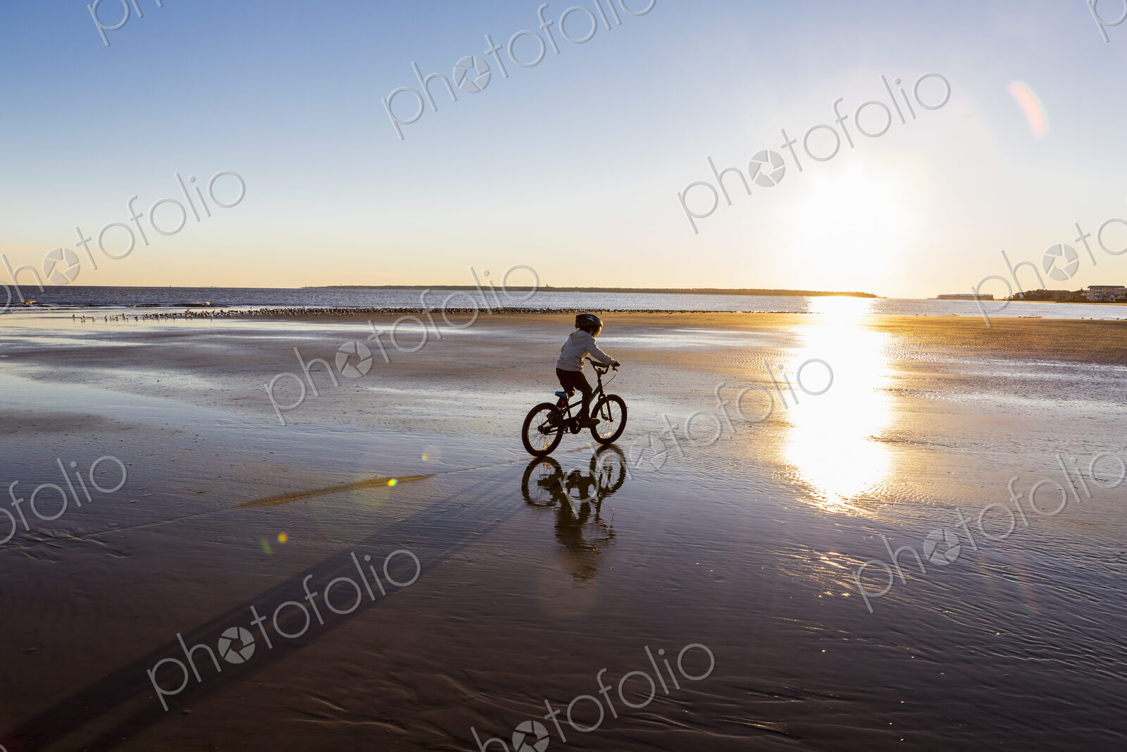 A boy riding a bicycle on the beach,St. Simon’s Island, Georgia