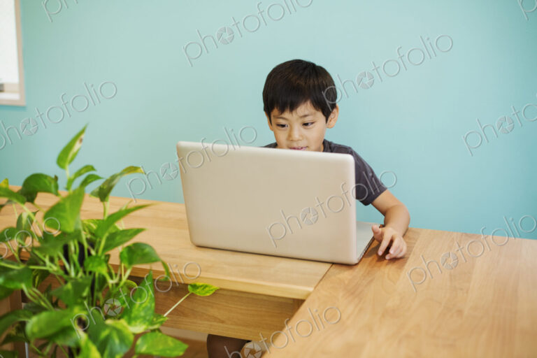 A boy using a computer in a classroom.