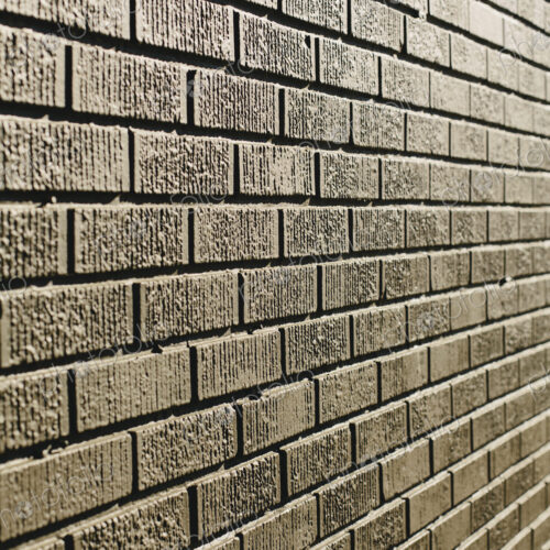 A brown brick wall in a city.