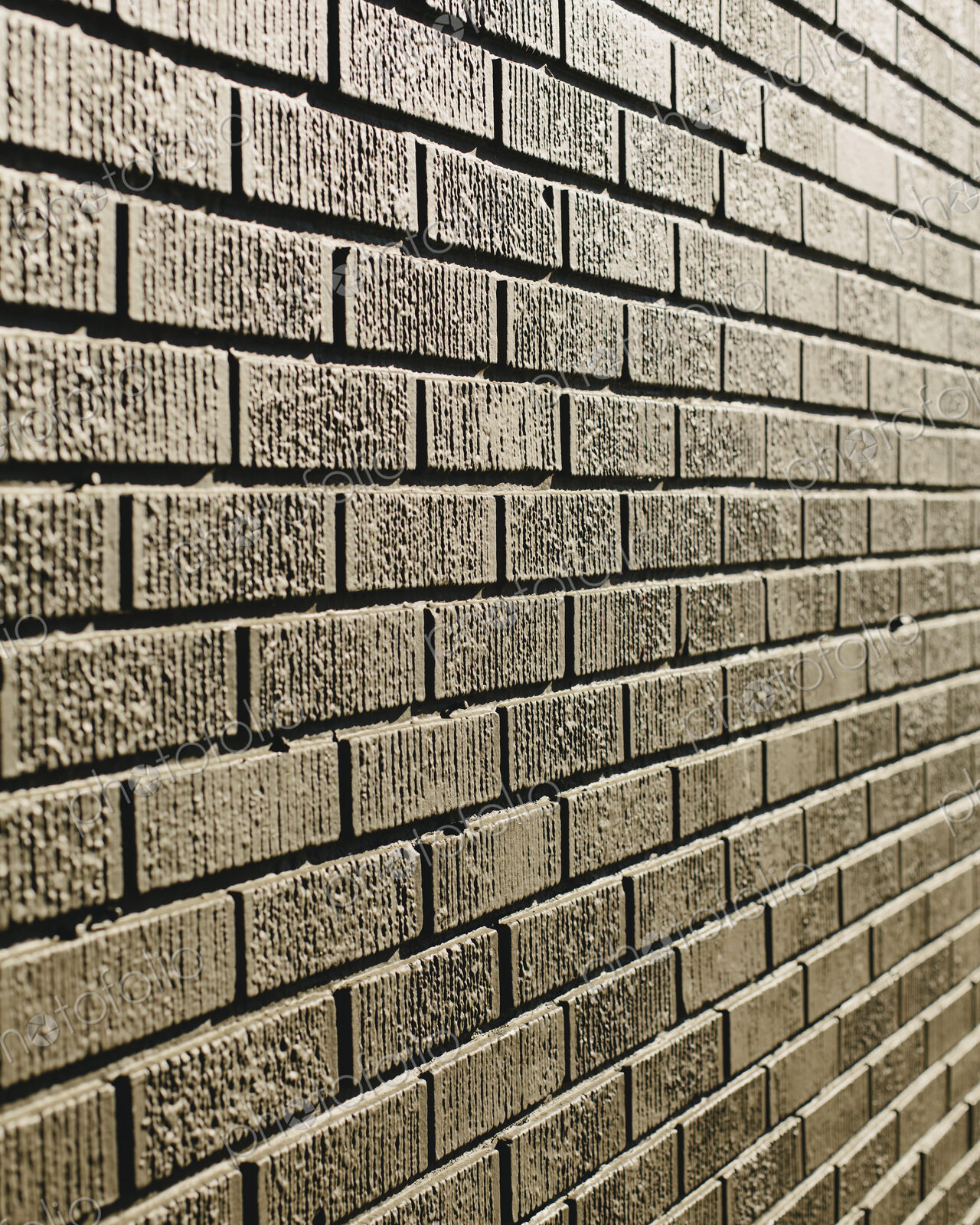 A brown brick wall in a city.