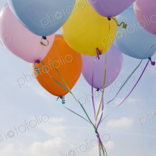 A bunch of balloons floating in the air. A bunch of balloons floating in the air.
