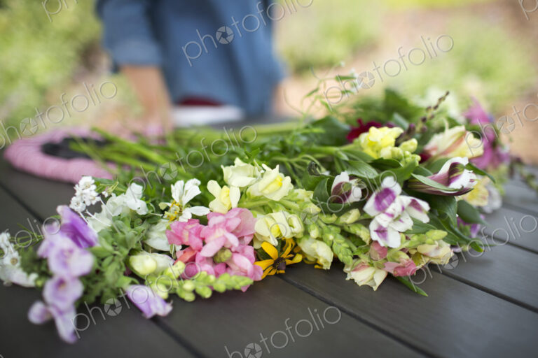 A bunch of summer garden flowers on an outdoor table.