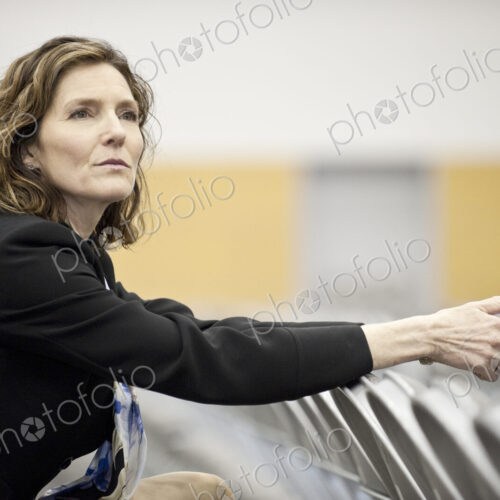 A businesswoman sitting alone in a room full of chairs prior to a meeting in a…
