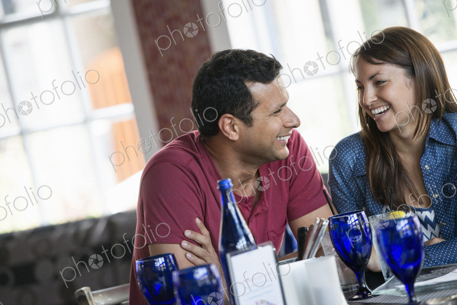 A cafe interior. A couple seated at a table.