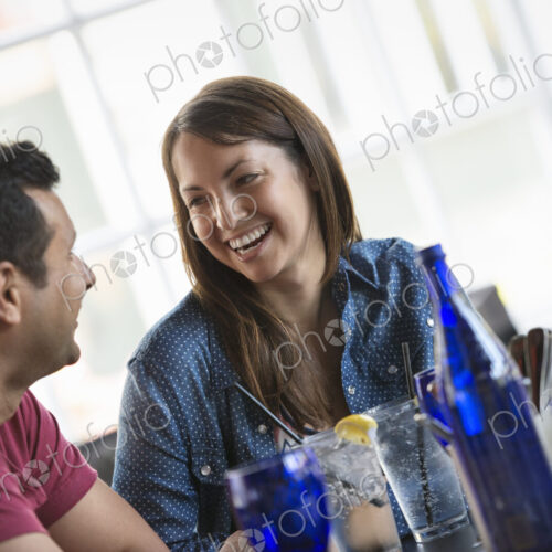A cafe interior. A couple seated at a table. A cafe interior. A couple seated at a table.