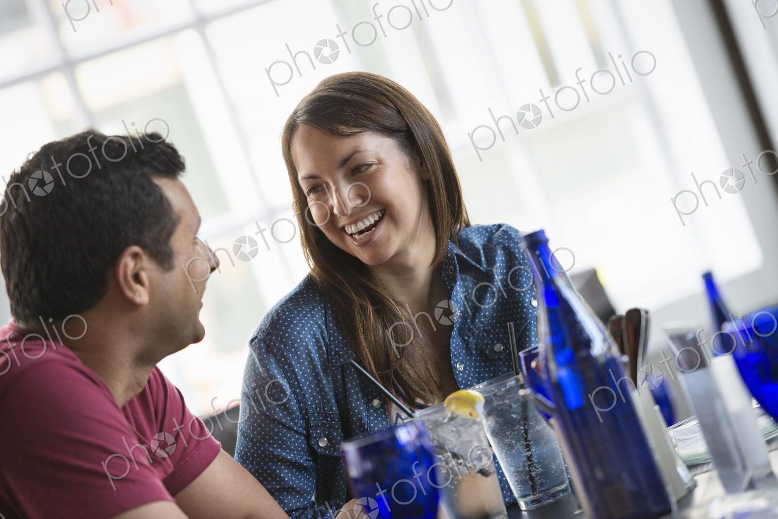 A cafe interior. A couple seated at a table.