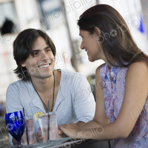 A cafe interior. A couple seated at a table. A cafe interior. A couple seated at a table.