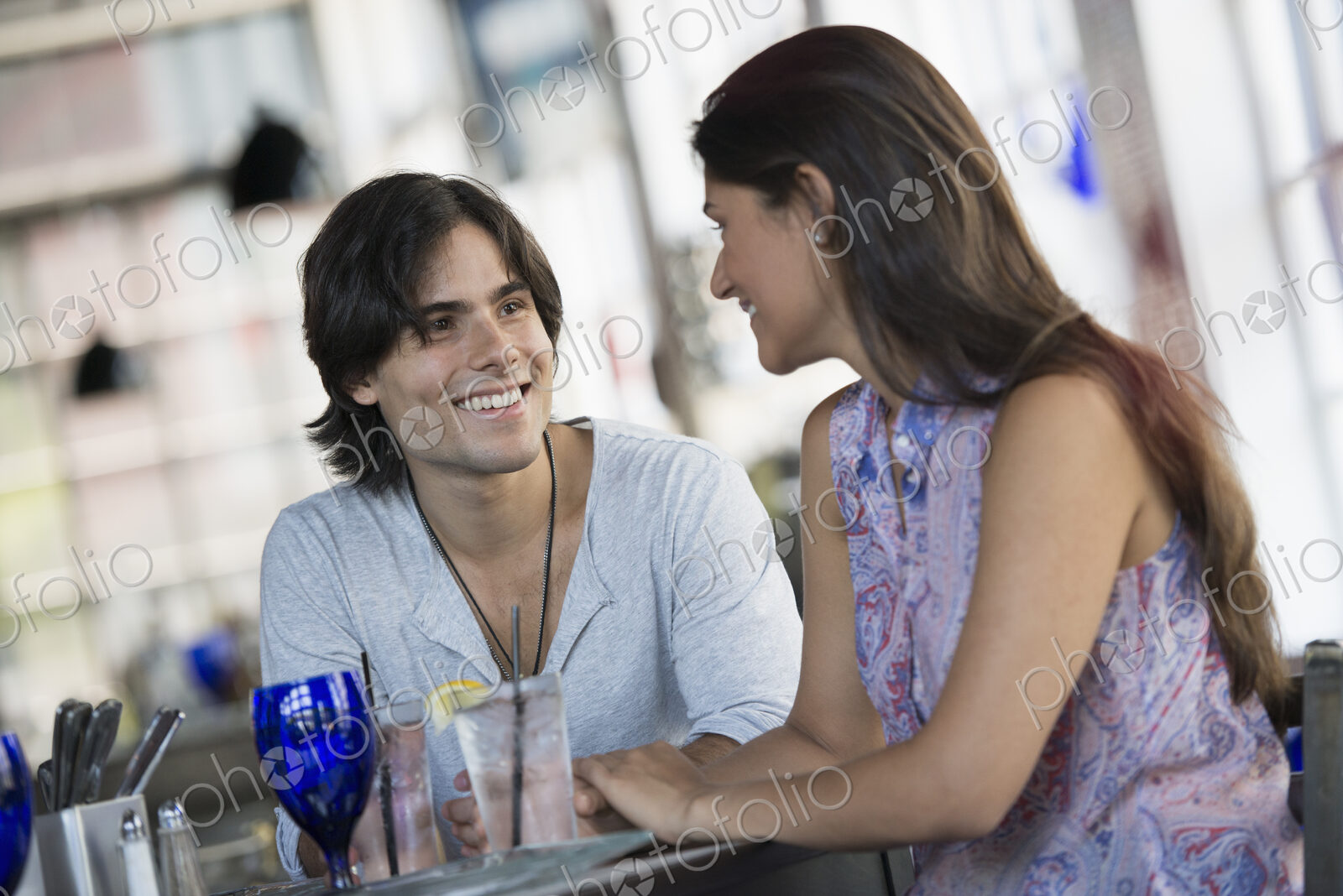 A cafe interior. A couple seated at a table.