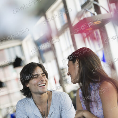 A cafe interior. A couple seated at a table. A cafe interior. A couple seated at a table.