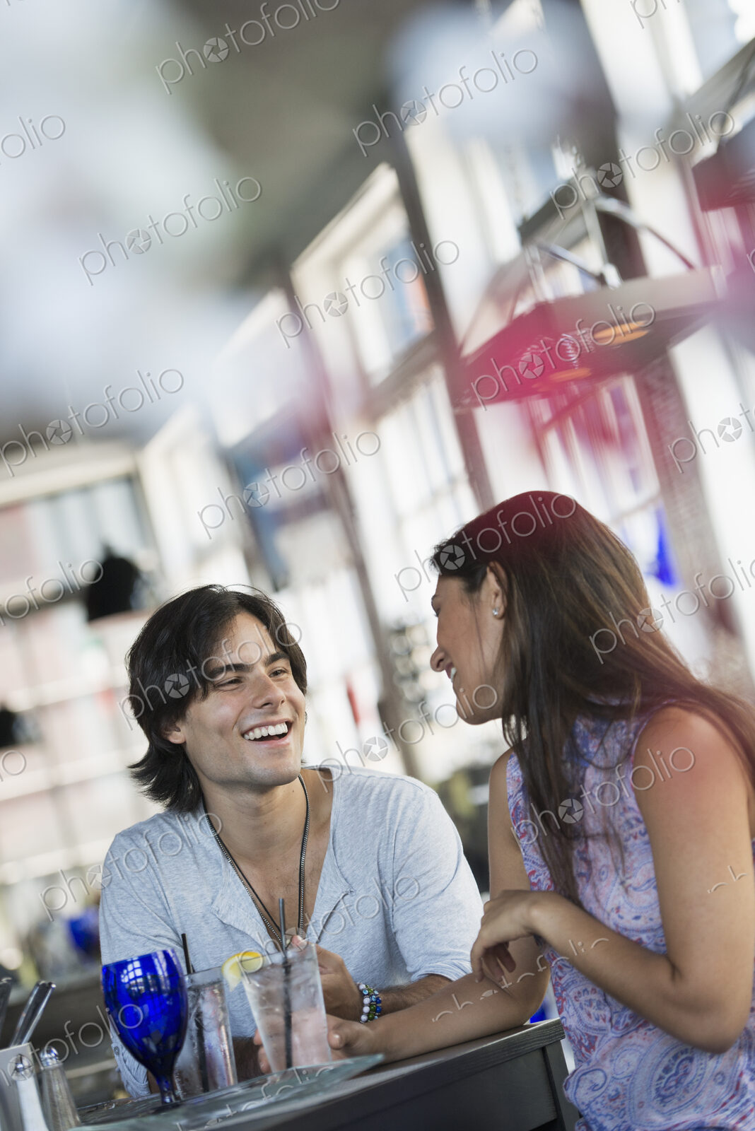 A cafe interior. A couple seated at a table.