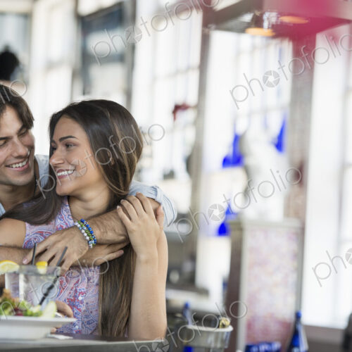 A cafe interior. A couple seated at a table. A cafe interior. A couple seated at a table.