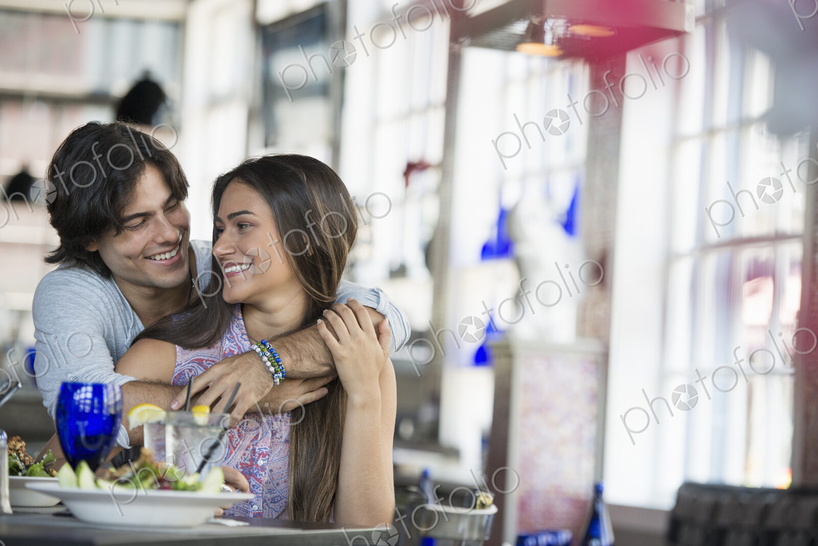 A cafe interior. A couple seated at a table.