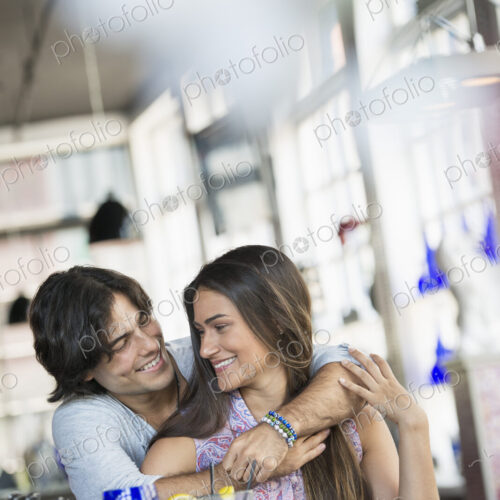 A cafe interior. A couple seated at a table. A cafe interior. A couple seated at a table.