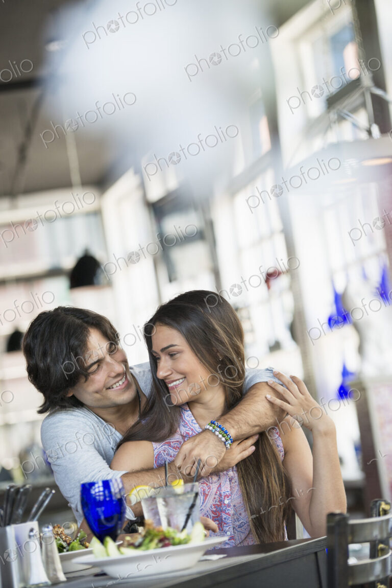 A cafe interior. A couple seated at a table.