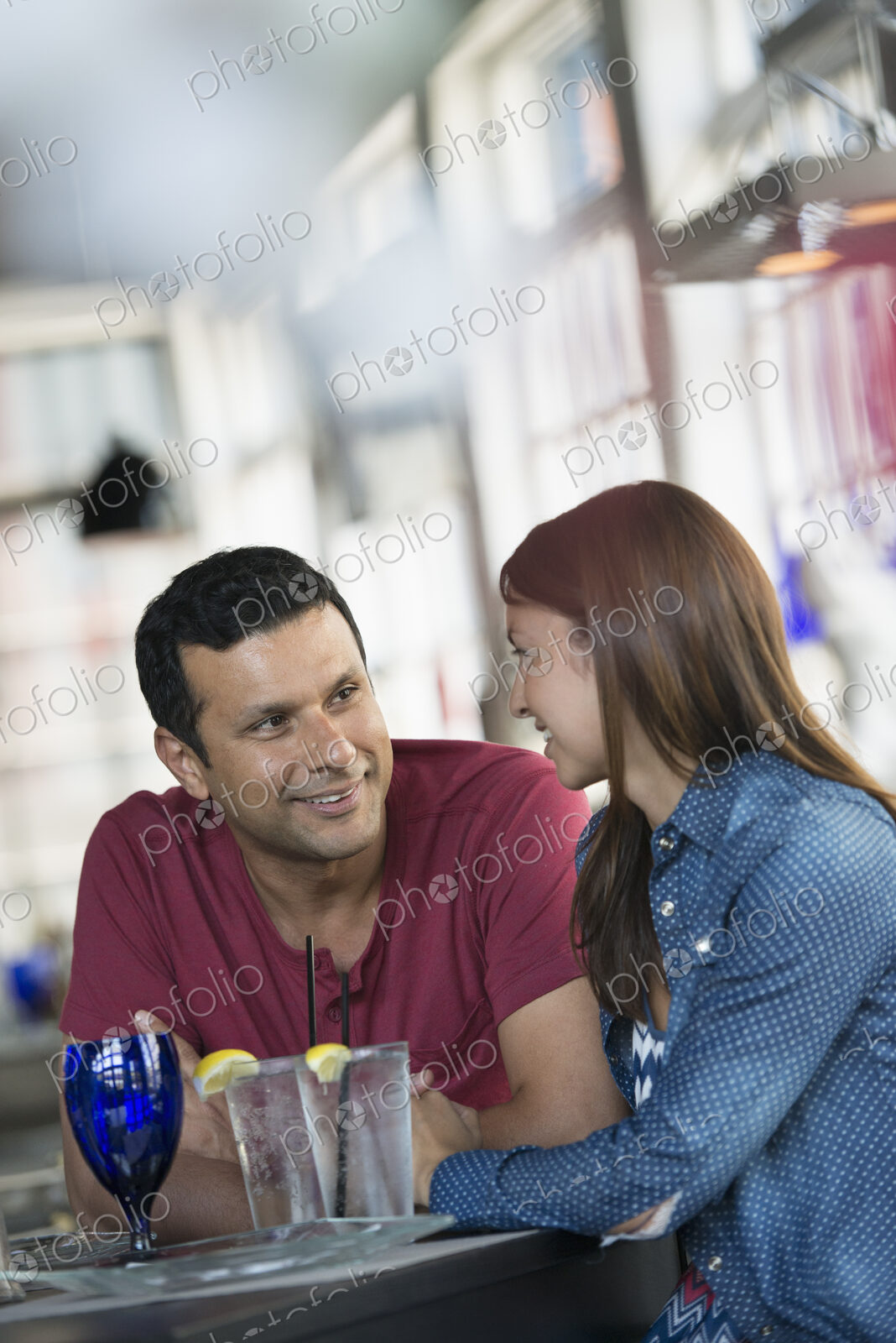 A cafe interior. A man and woman seated at a table.