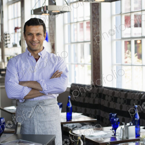 A cafe interior. A man in chef's whites. A cafe interior. A man in chef's whites.