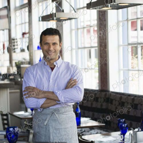 A cafe interior. A man in chef's whites. A cafe interior. A man in chef's whites.