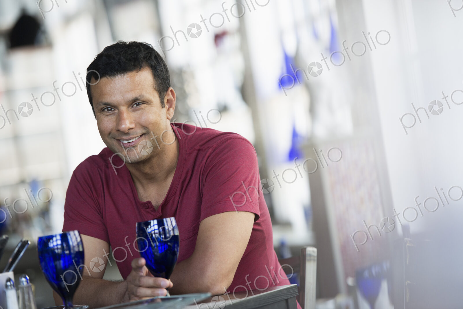 A cafe interior. A man sitting at a table.