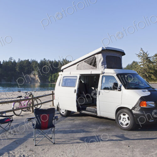 A camper van parked in a cove on Cape Arago on the Oregon coast., camping chairs and… A camper van parked in a cove on Cape Arago on the Oregon coast., camping chairs and…