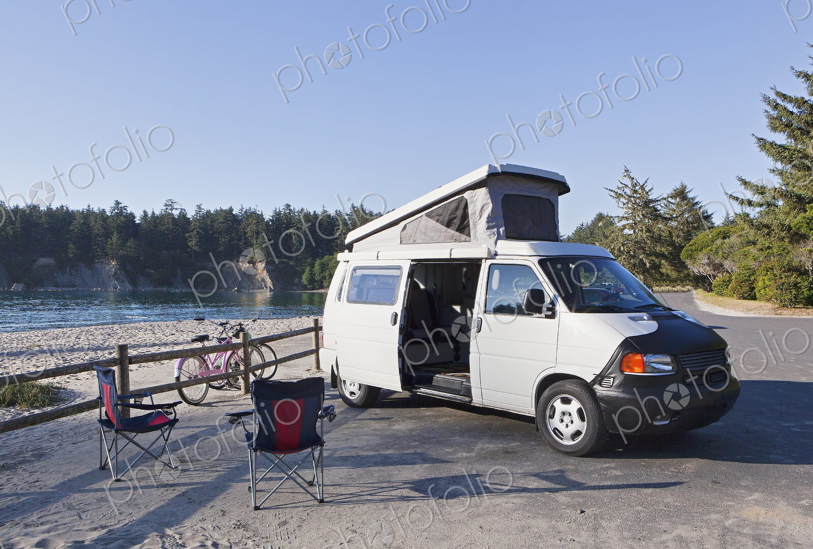 A camper van parked in a cove on Cape Arago on the Oregon coast., camping chairs and…