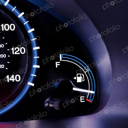 A car interior, the dashboard,instrument panel,and fuel gauge. A speedometer A car interior, the dashboard,instrument panel,and fuel gauge. A speedometer