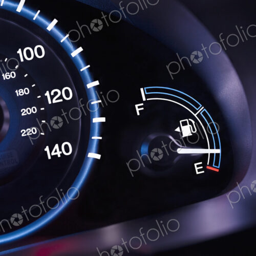 A car interior, the dashboard,instrument panel,and fuel gauge. A speedometer. A car interior, the dashboard,instrument panel,and fuel gauge. A speedometer.