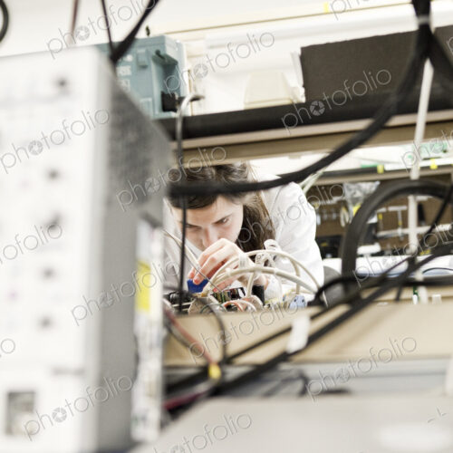A caucaasian female techinician working over a problem in a technical research and… A caucaasian female techinician working over a problem in a technical research and…