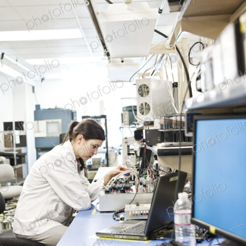 A caucaasian female techinician working over a problem in a technical research and… A caucaasian female techinician working over a problem in a technical research and…