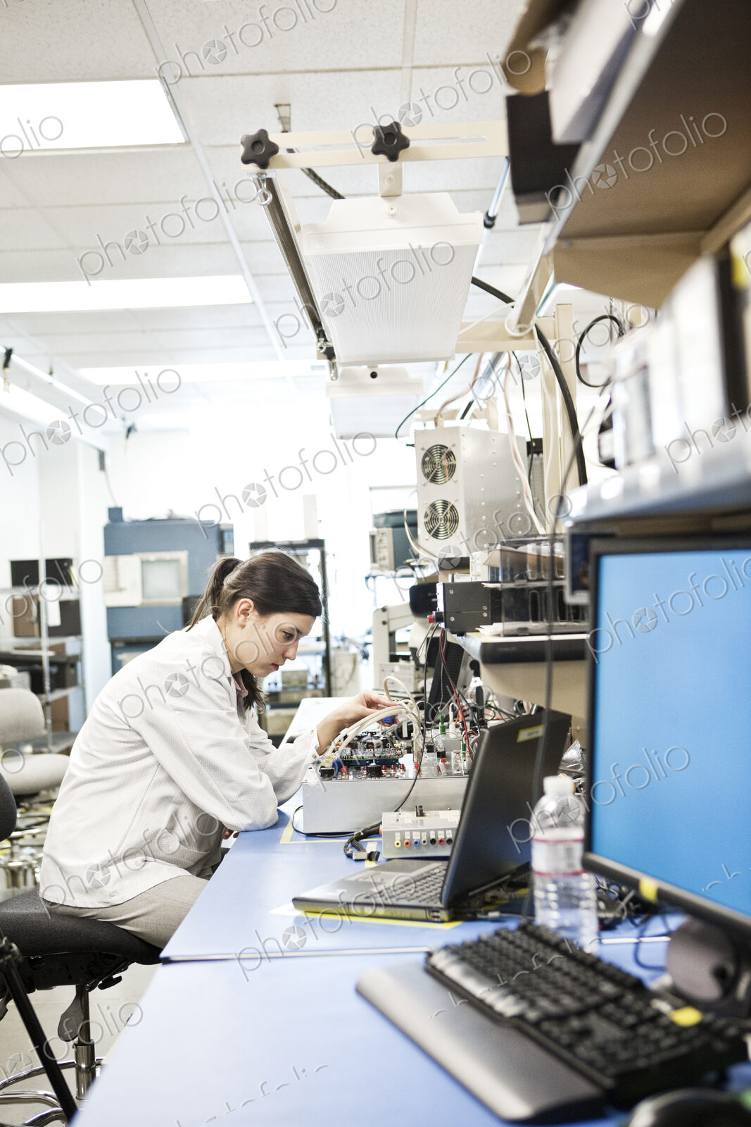 A caucaasian female techinician working over a problem in a technical research and…