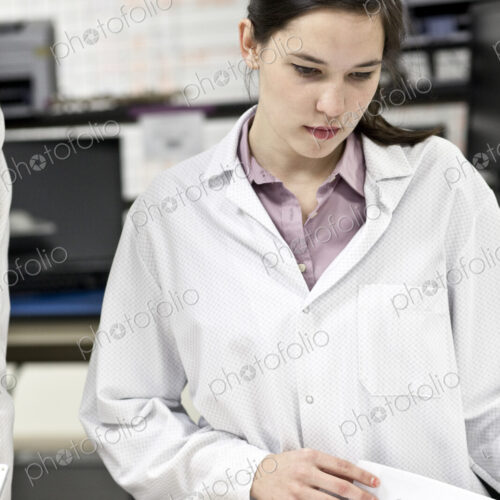 A caucaasian female techinician working over a problem in a technical research and…