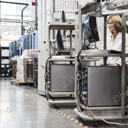 A caucaasian female techinician working over a problem in a technical research and…