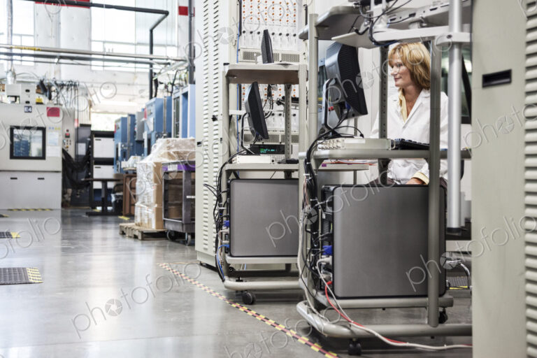 A caucaasian female techinician working over a problem in a technical research and…