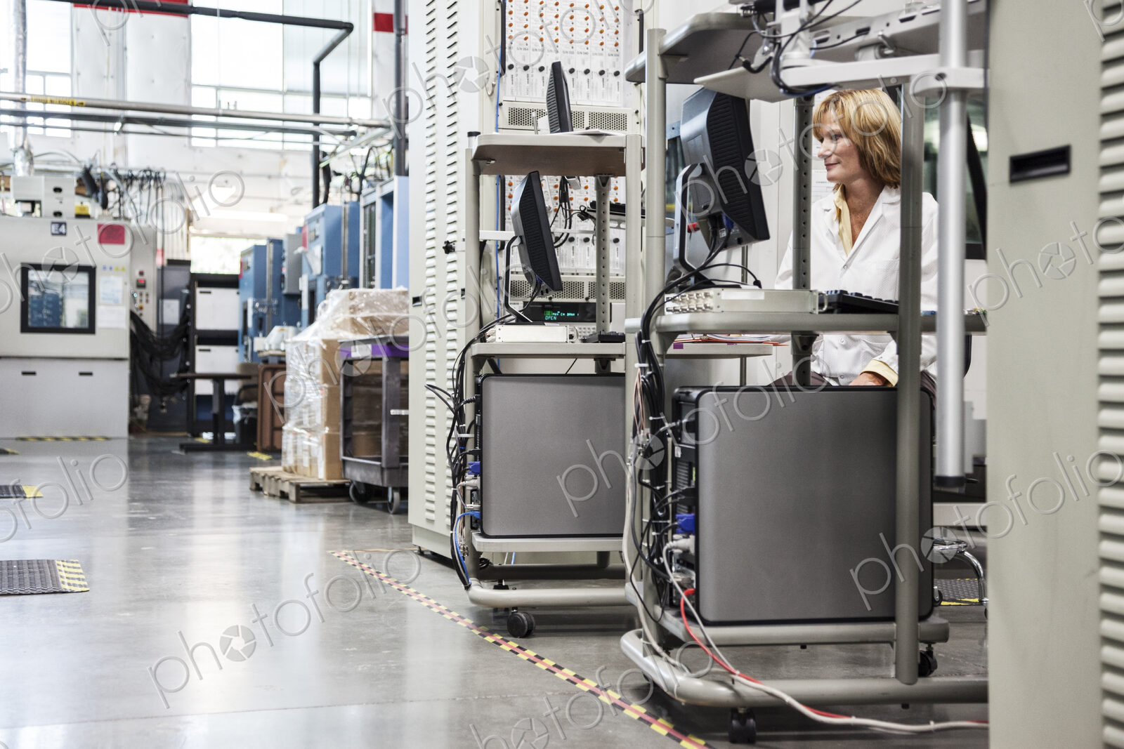 A caucaasian female techinician working over a problem in a technical research and…