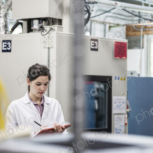 A caucaasian female techinician working over a problem in a technical research and…