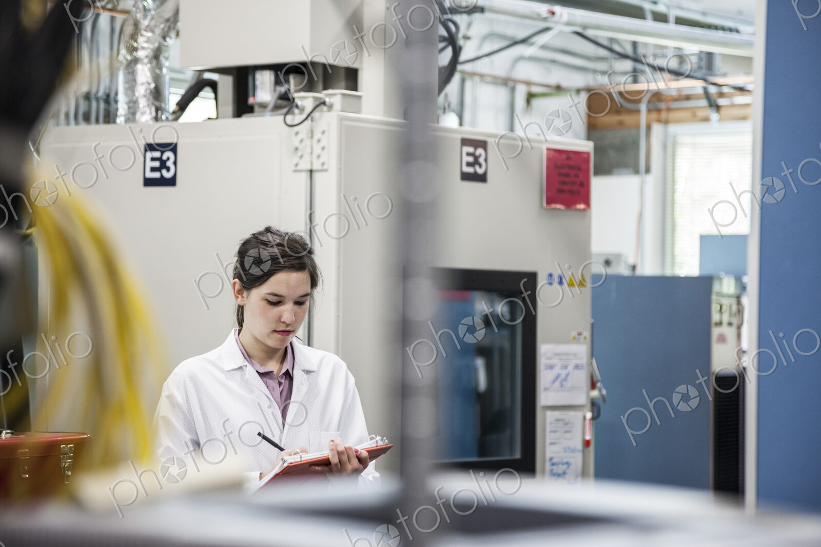 A caucaasian female techinician working over a problem in a technical research and…