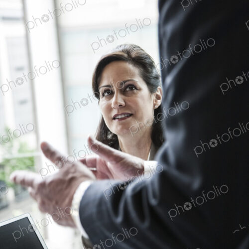 A caucasian buisnesswoman listening to a conversation in a business meeting. A caucasian buisnesswoman listening to a conversation in a business meeting.