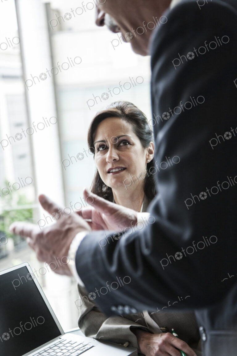 A caucasian buisnesswoman listening to a conversation in a business meeting.