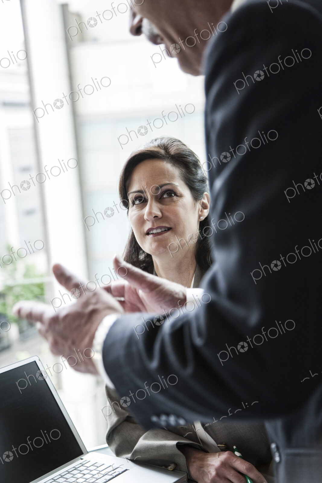 A caucasian buisnesswoman listening to a conversation in a business meeting.