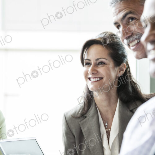 A caucasian buisnesswoman listening to a conversation in a business meeting. A caucasian buisnesswoman listening to a conversation in a business meeting.