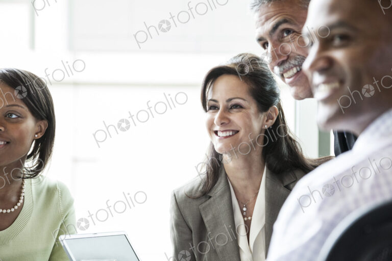 A caucasian buisnesswoman listening to a conversation in a business meeting.