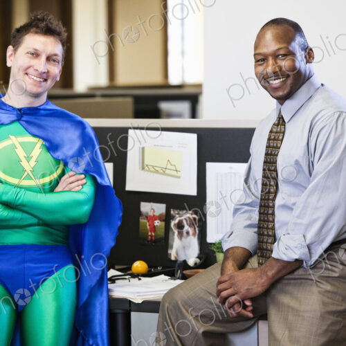 A caucasian businessman office super hero and his black business man partner. A caucasian businessman office super hero and his black business man partner.