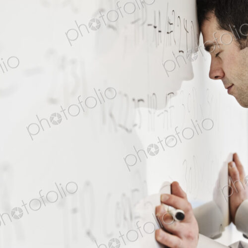 A caucasian businessman under stress from over working. A caucasian businessman under stress from over working.
