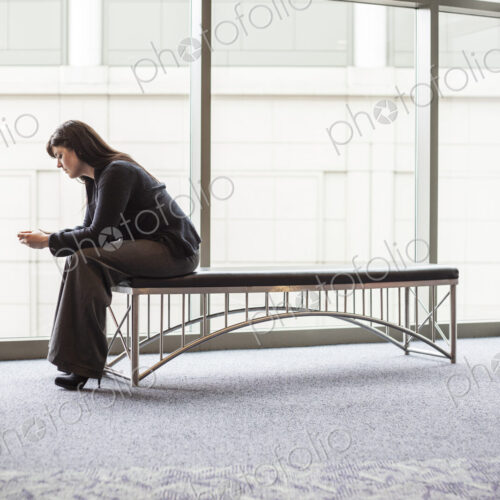 A caucasian businesswoman working on a cell phone. A caucasian businesswoman working on a cell phone.