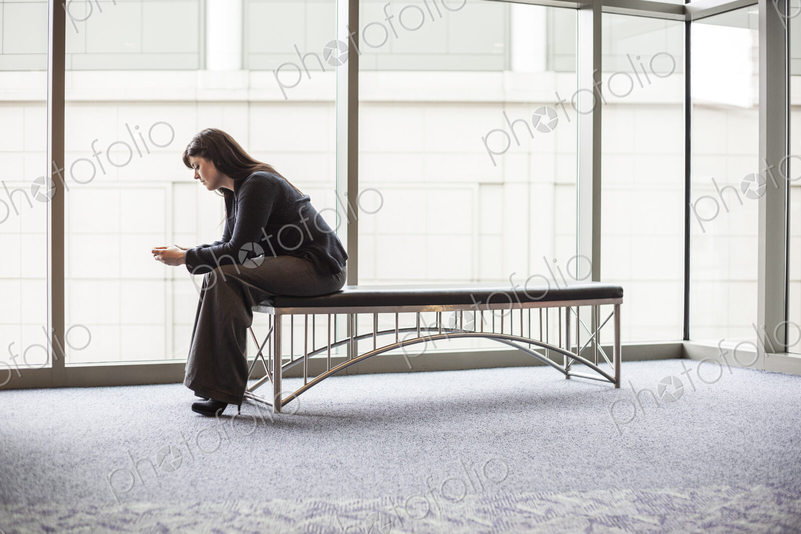 A caucasian businesswoman working on a cell phone.