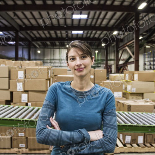 A caucasian female warehouse worker in a distribution warehouse.